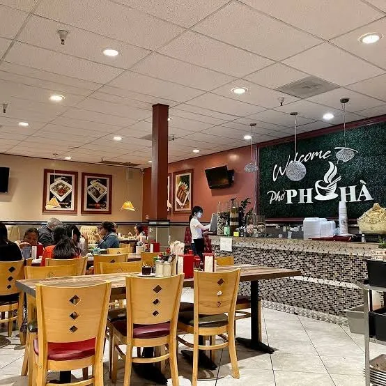 Dining room at the Phở Hà Temecula location, with the welcome sign behind the counter